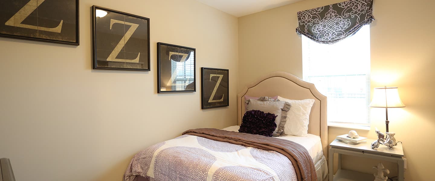 A cozy bedroom with decorative pillows and modern decor.