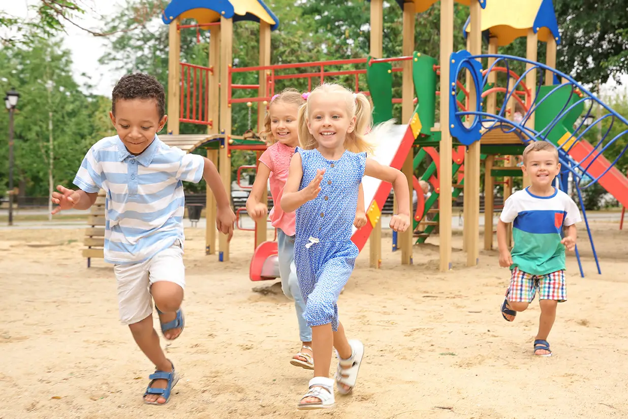 Children running and playing on a playground.