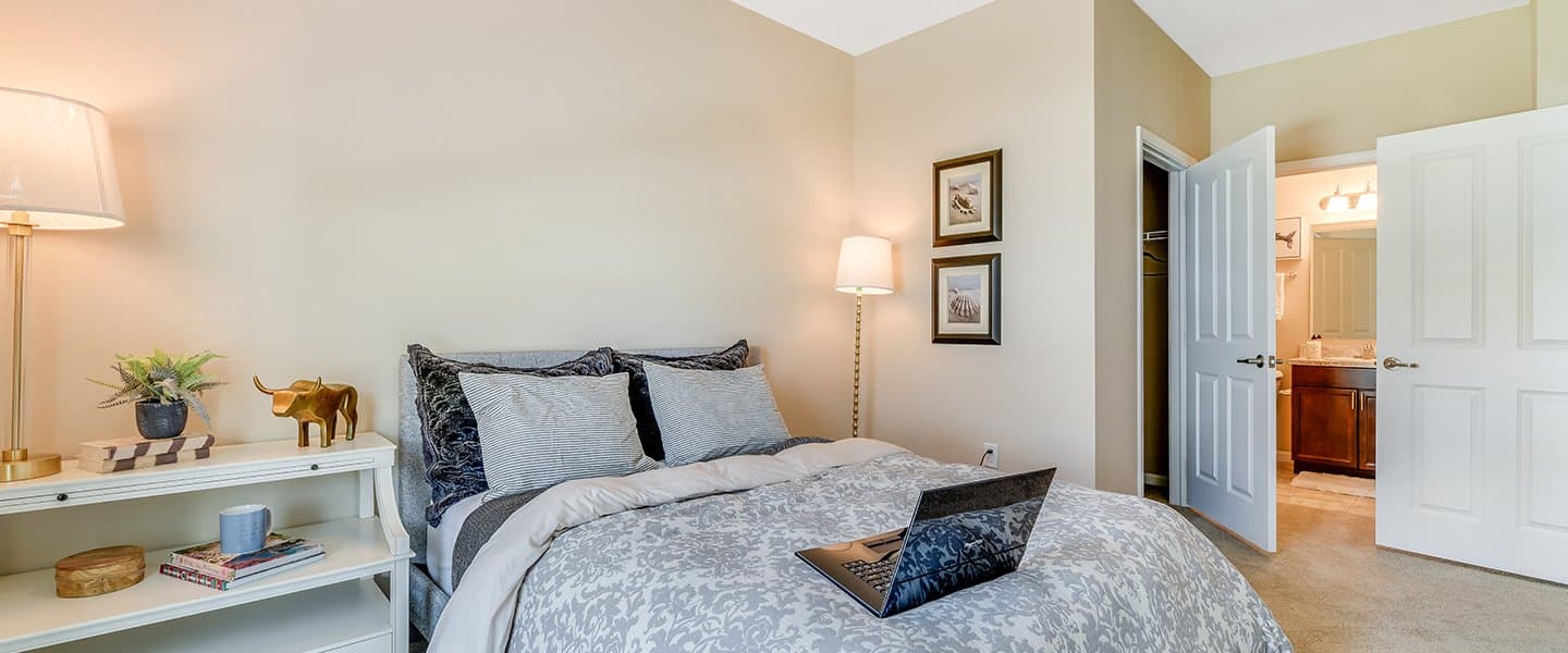 A cozy bedroom with decorative pillows and modern decor.