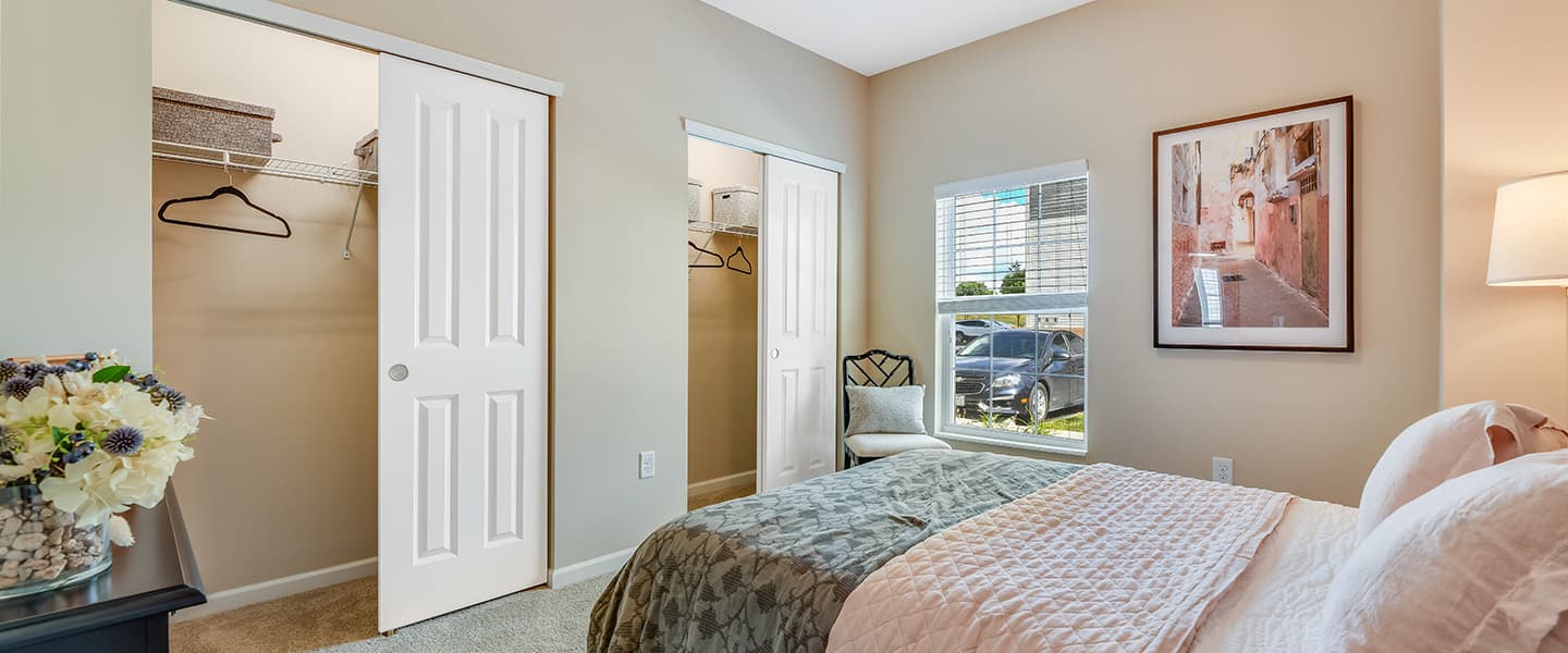 A cozy bedroom with decorative pillows and modern decor.