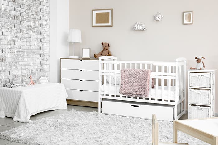 A light color palleted nursery room for apartment living with a baby