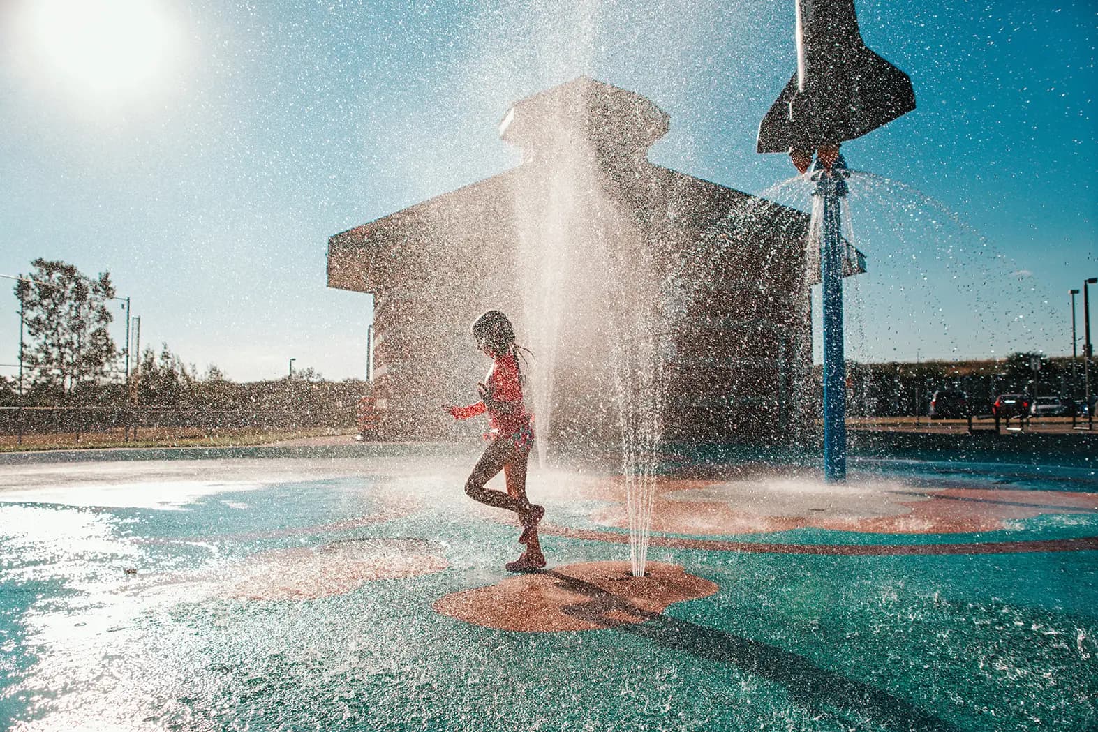 a young kid playing at a waterpark.