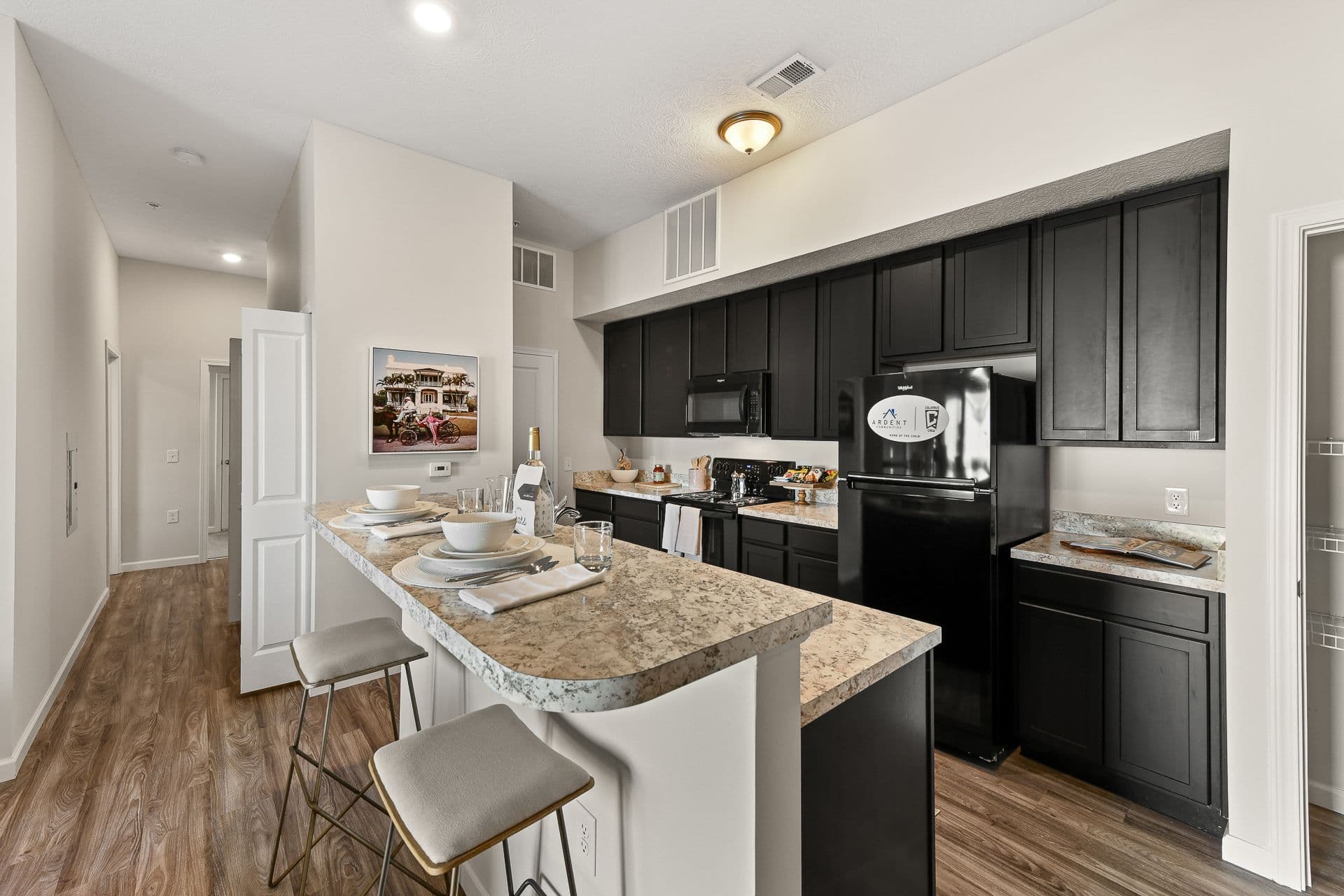 A kitchen with a kitchen island and black cabinets
