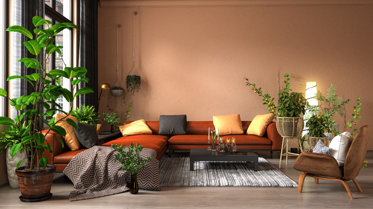 Living room with a red couch on a carpet and plants on both sides.