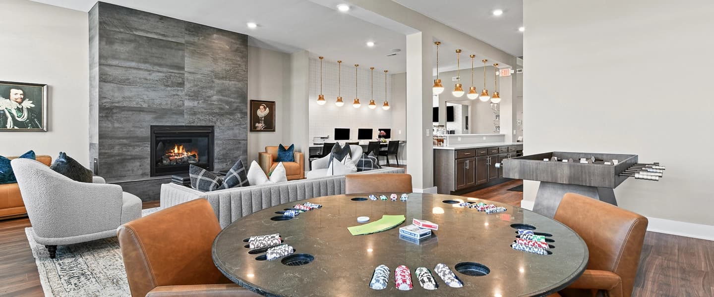 Community area with comfortable seating, desks with computers, and island seating for residents