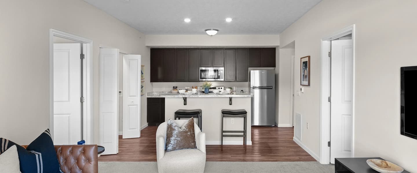 Living room with open access to the kitchen featuring a modern, open-concept layout
