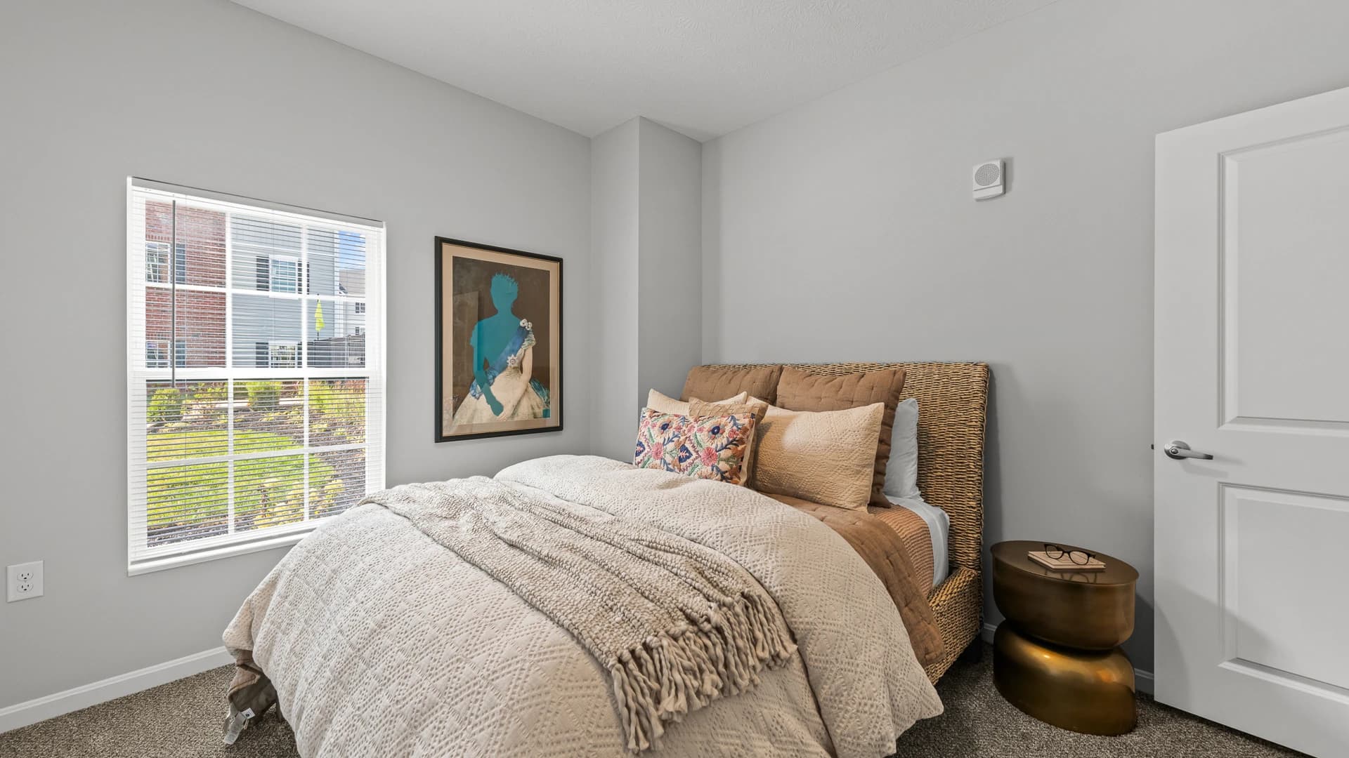 Cozy bed next to a window in an Etna Ohio apartment bedroom
