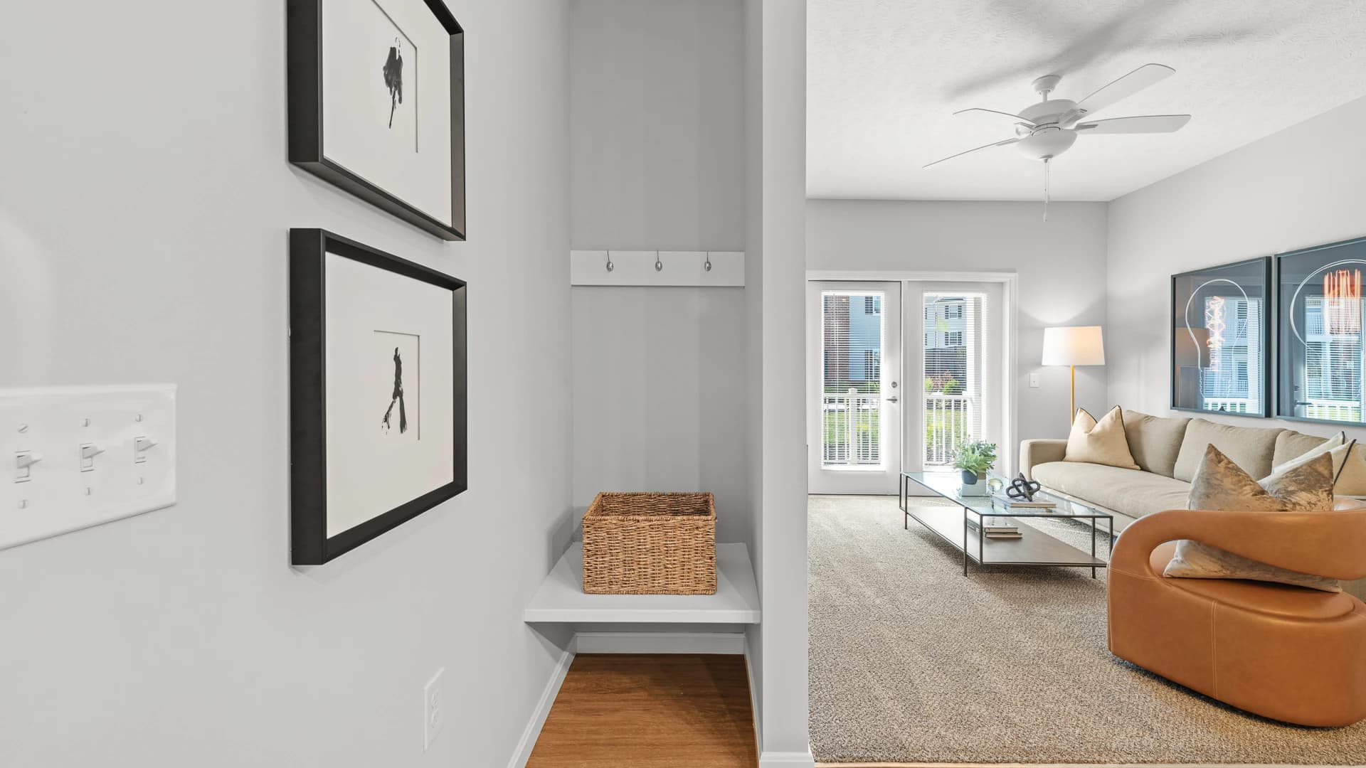 Coat closet next to a large living room with modern furniture in an Etna Ohio apartment unit