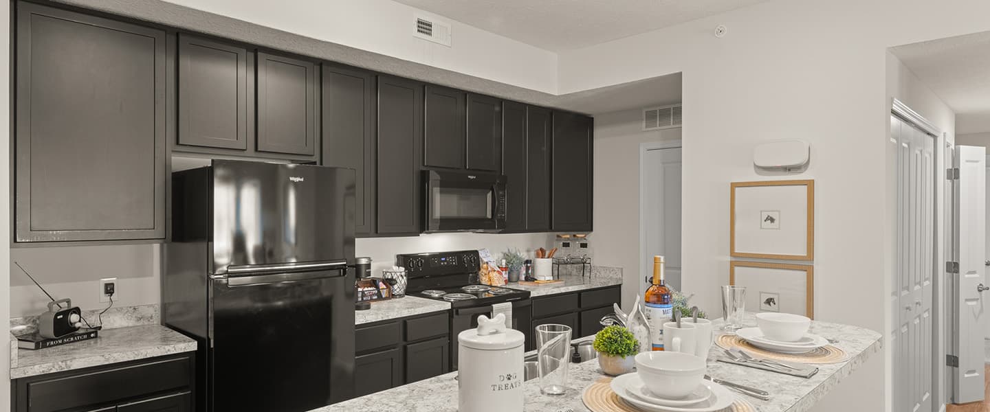 Island, counter and black appliances in a Powell Ohio apartment unit