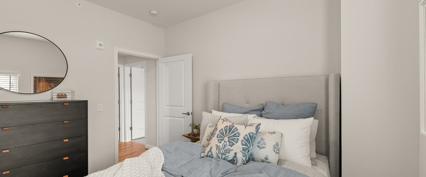 Cozy bedroom with bed and dresser in a Powell Ohio apartment