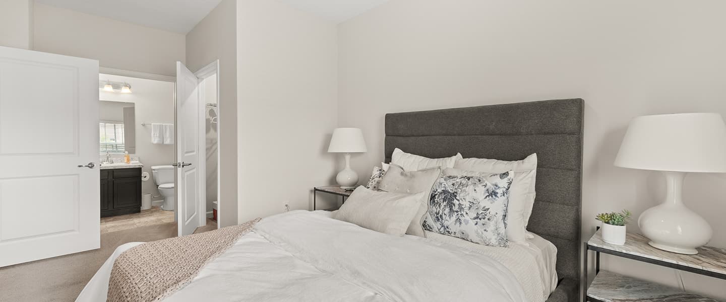 View of bedroom and attached private bathroom and walk in closet in a Powell Ohio apartment unit