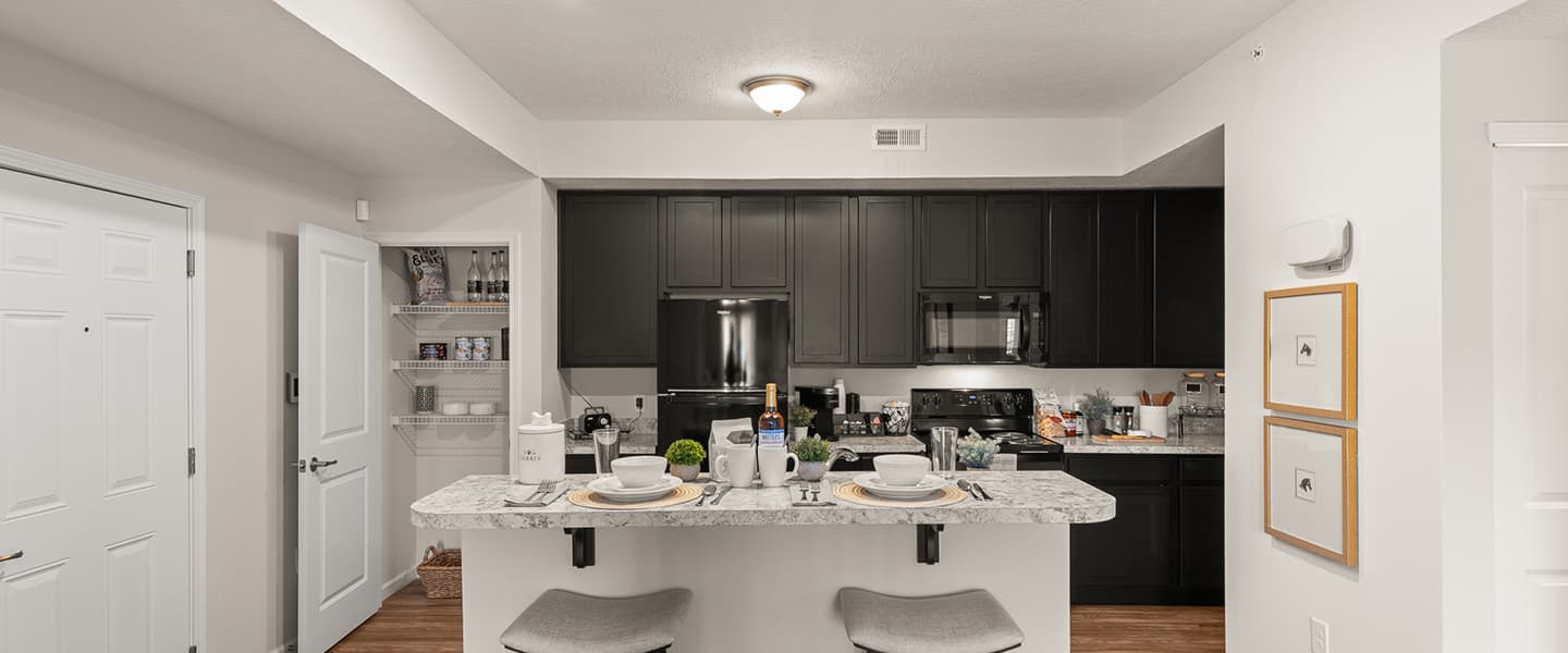 Wide view of a spacious kitchen and pantry area in a Powell Ohio apartment unit