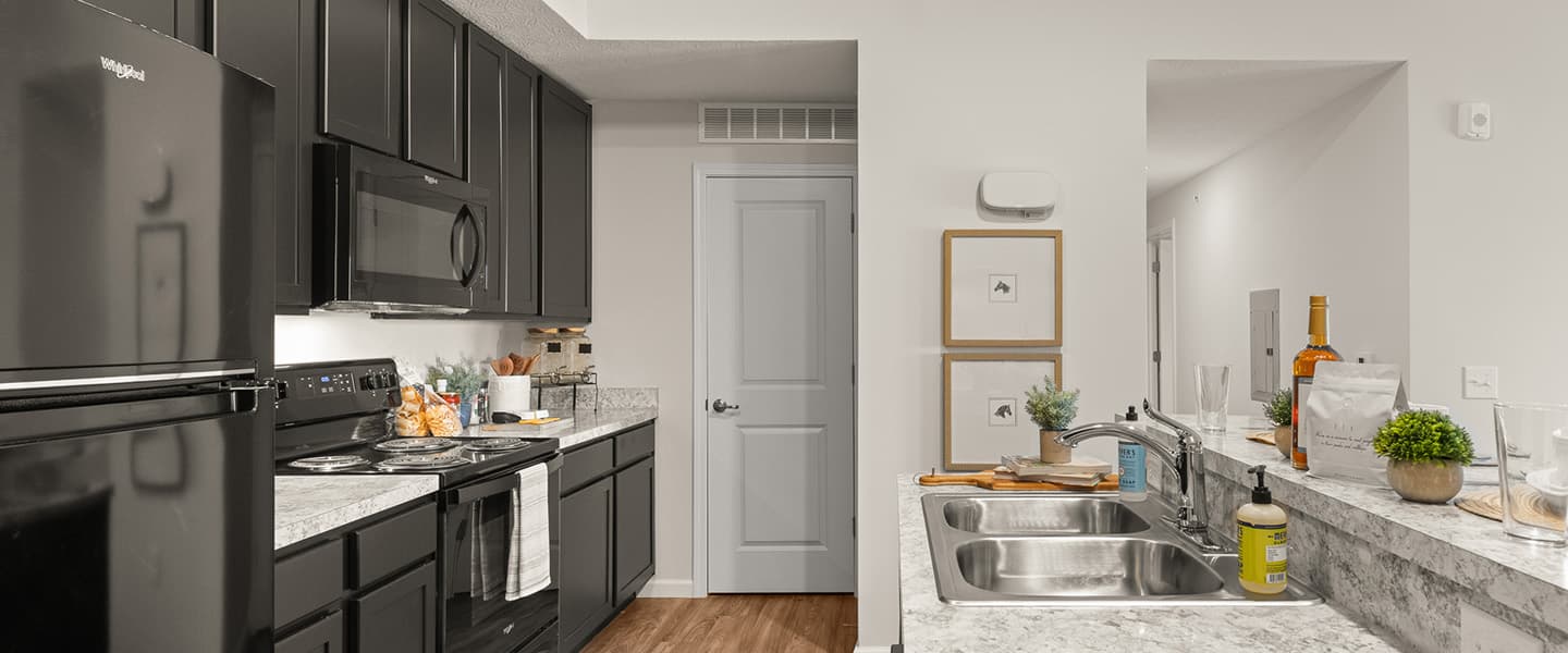 View of kitchen, hallway and pantry door in a Powell Ohio apartment unit