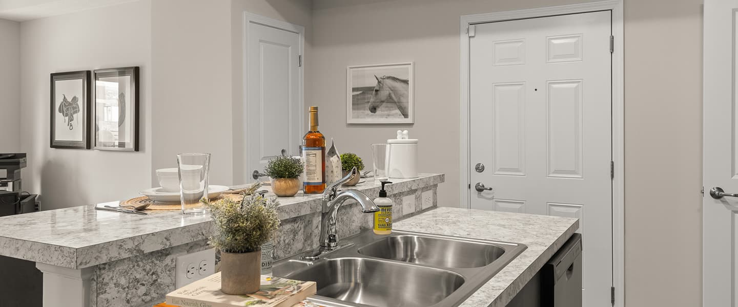 Island area with sink and counter in the kitchen of a Powell Ohio apartment unit
