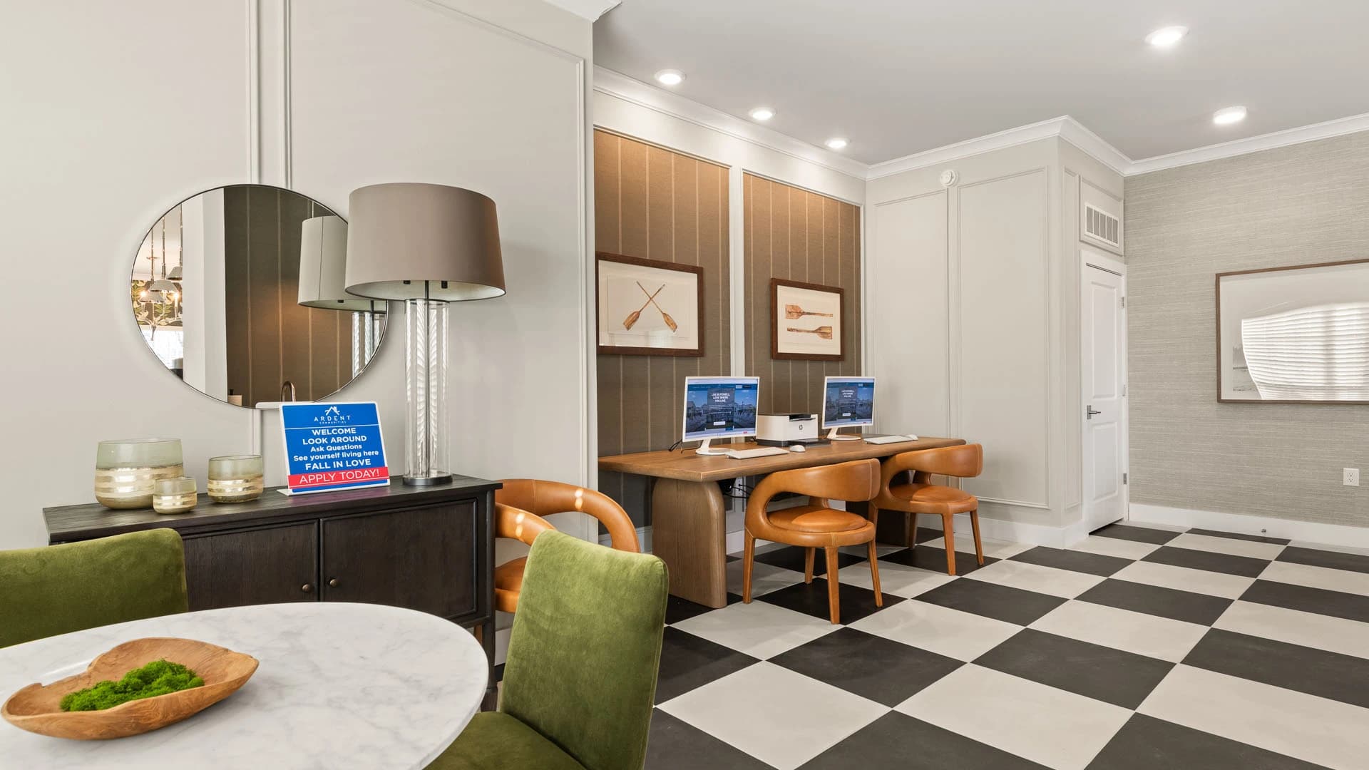 Lobby and common area with table and chairs and computers at a Grove City apartment community