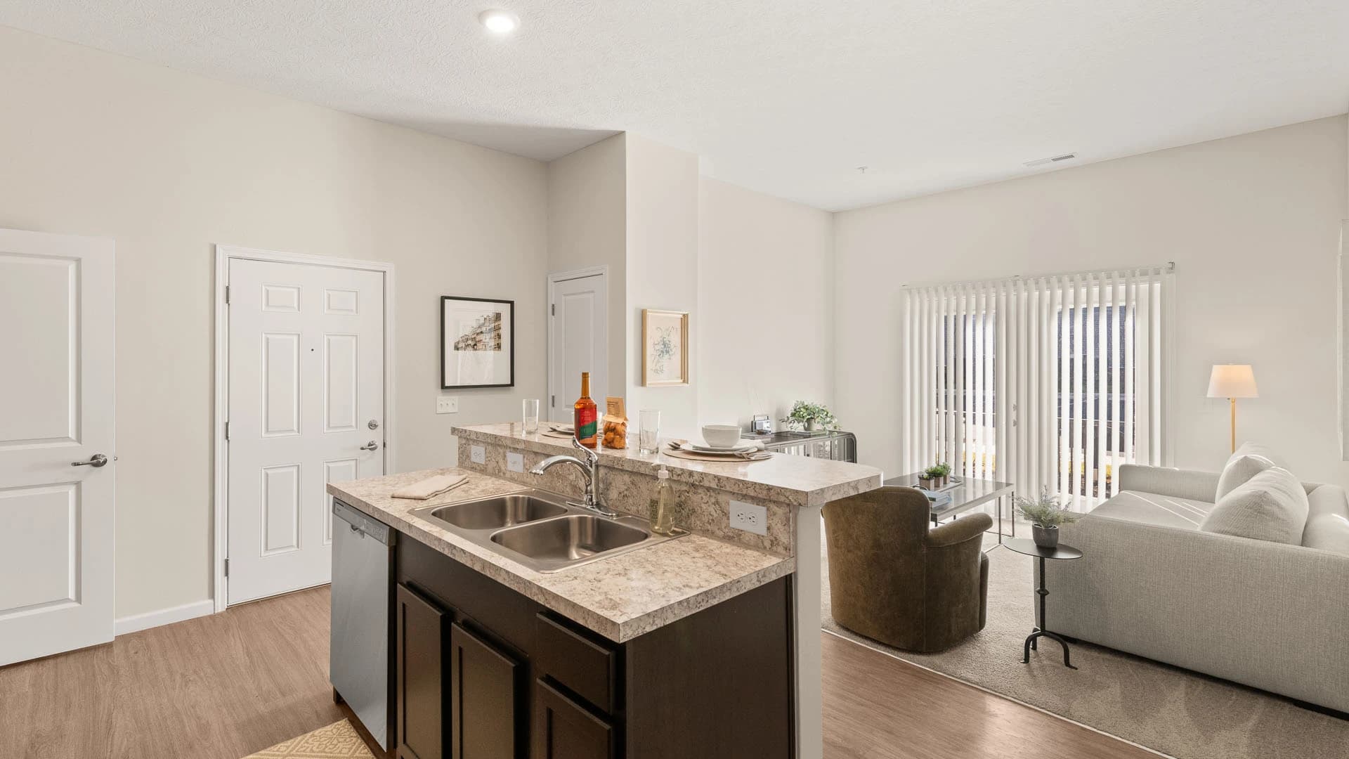 Kitchen island and attached living room space in a Grove City apartment unit