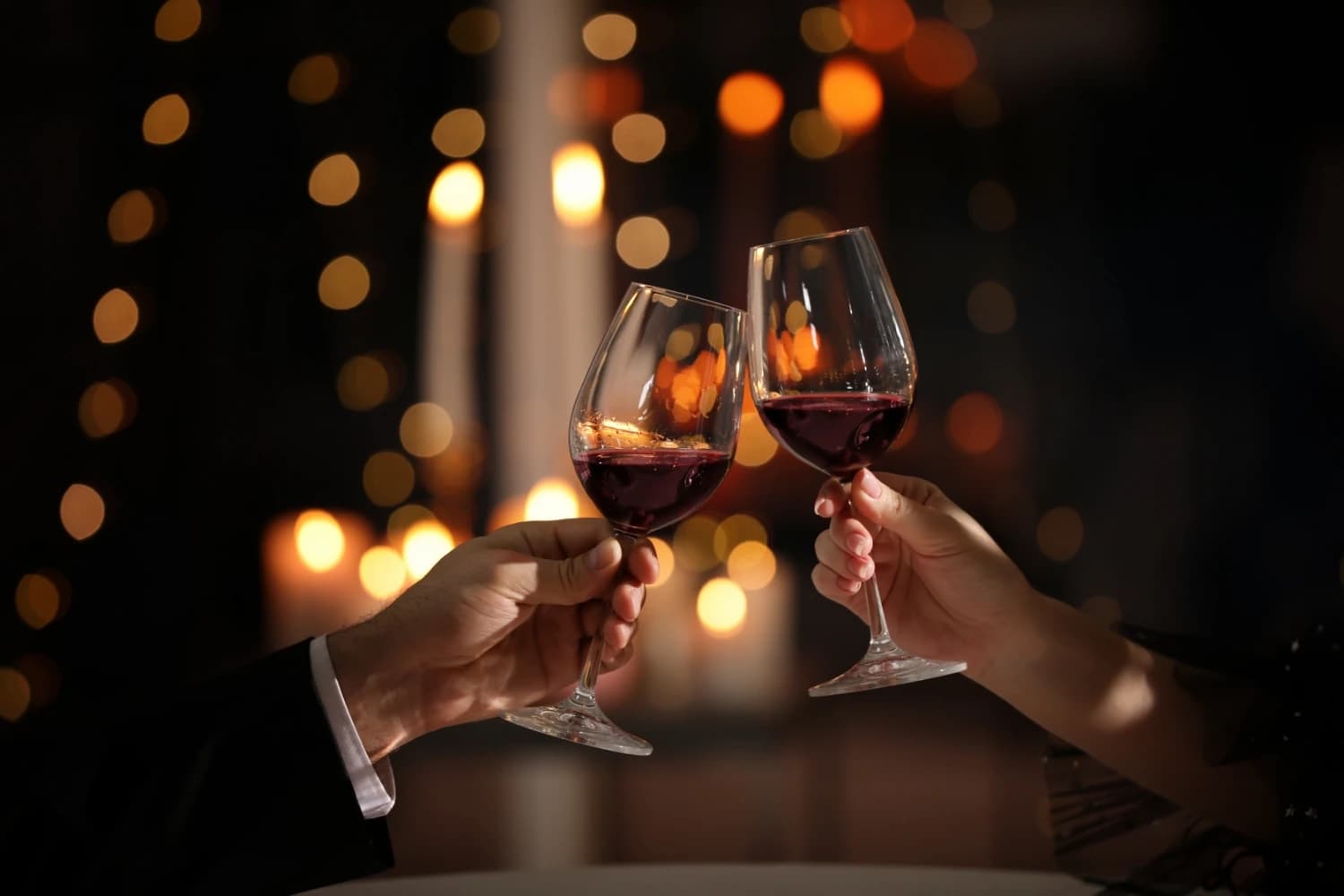 couple raising a toast with wine glasses