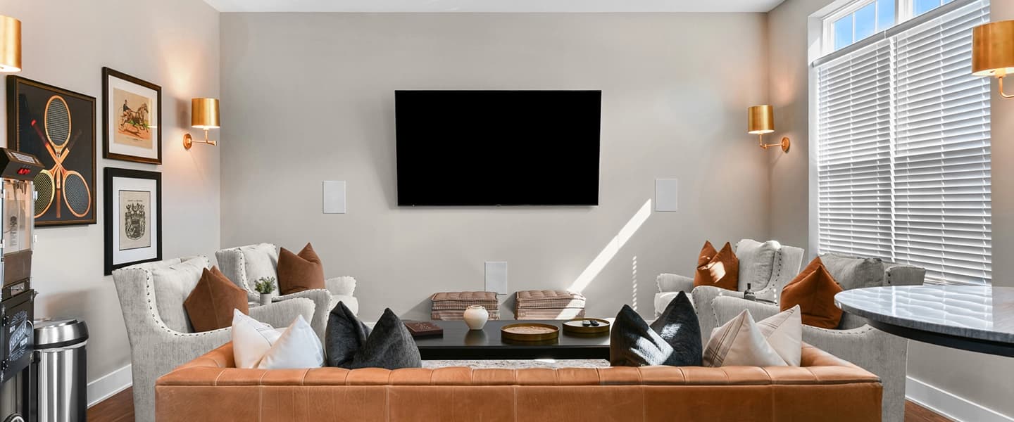 Resident lounge featuring seating and a television for entertainment