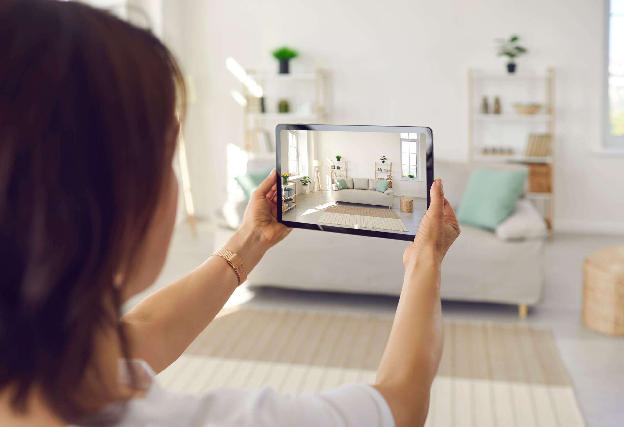 Woman viewing interior of an apartment through her device