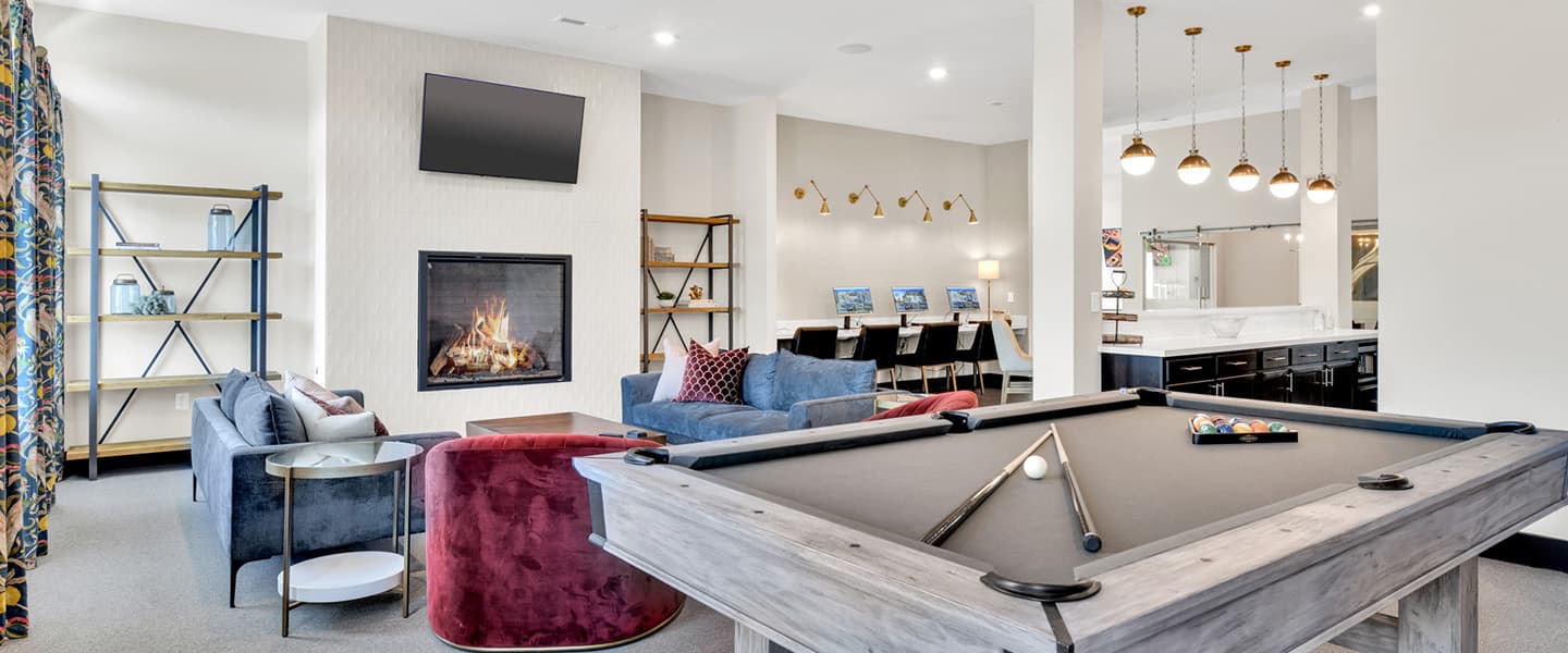 Resident lounge with pool table, seating, and computer workstations