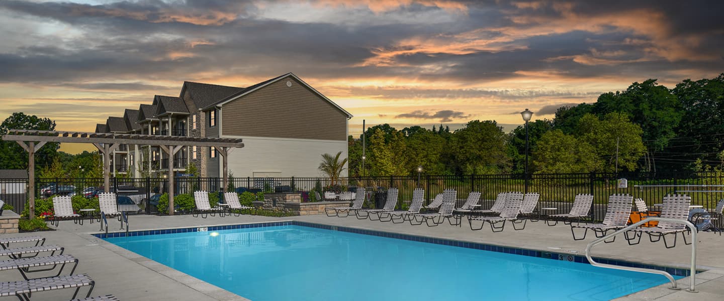 Beautiful pool at Woodfield Park with lounge chairs surrounding