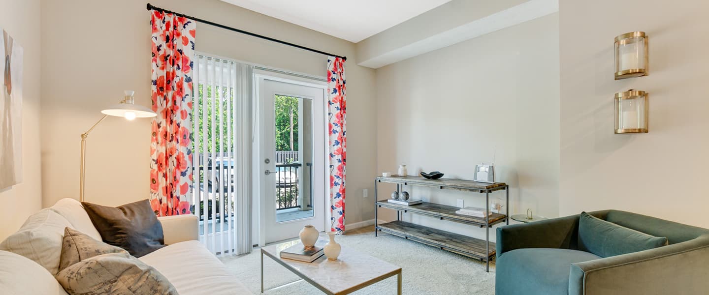 Living room with access to balcony featuring natural light and modern interior design