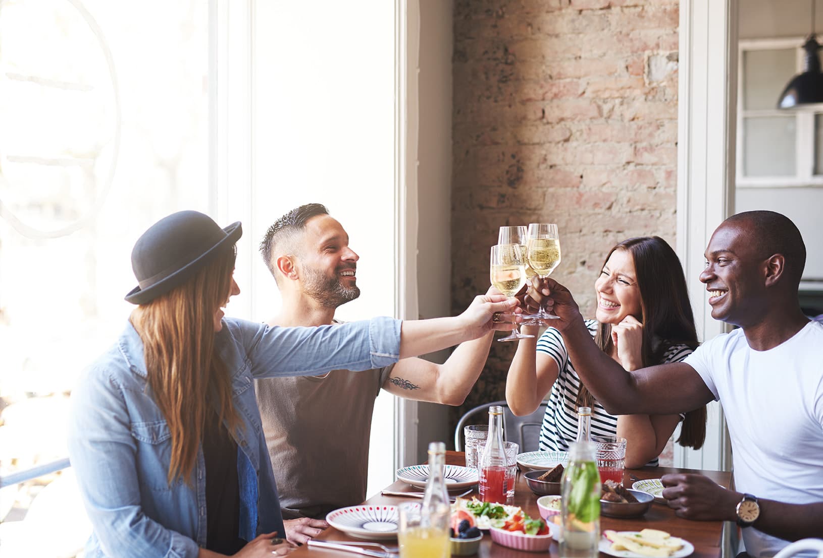 Two couples toasting with champagne.