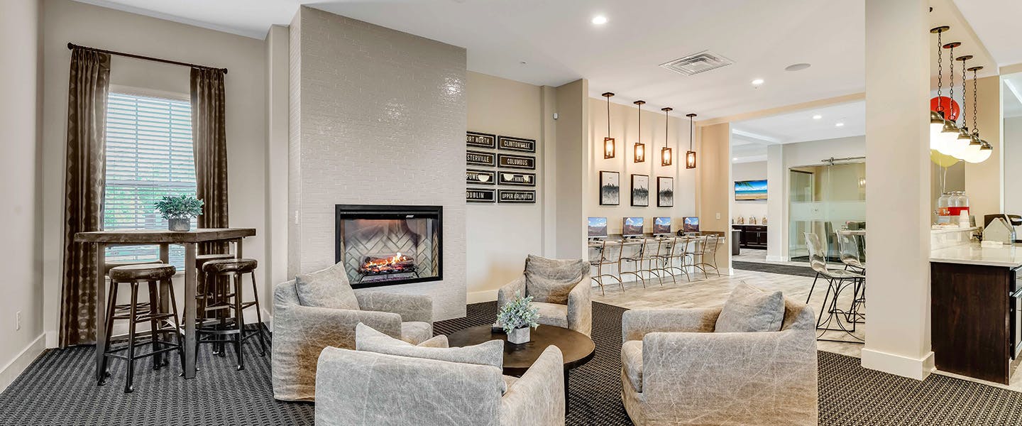 A community space complete with furniture, modern decor and a fireplace.
