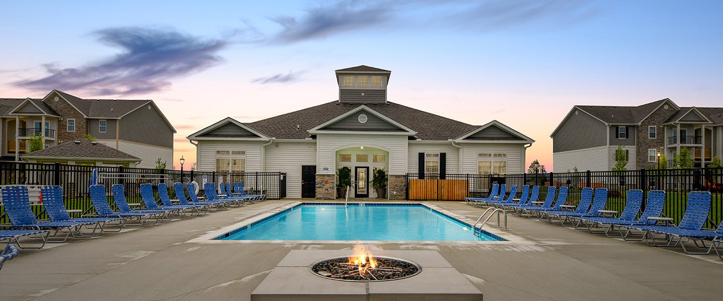 A beautiful pool complete with outdoor seating and umbrellas.