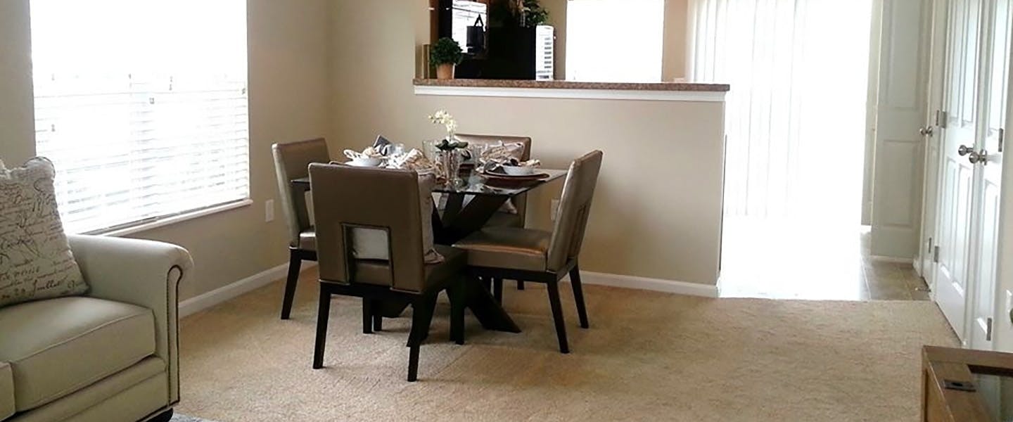 An open dining room layout complete with a table and modern decor.